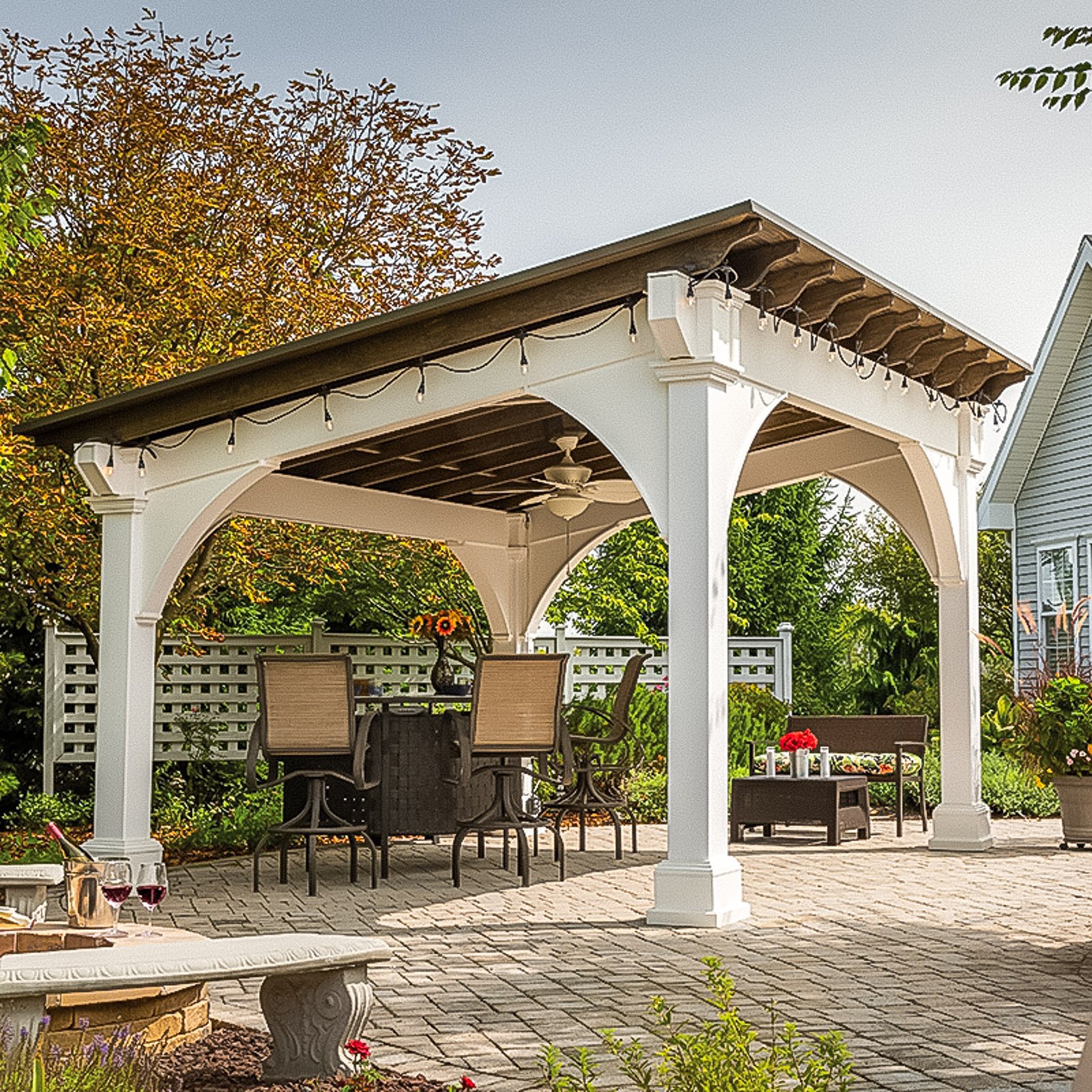 Freestanding vinyl pavilion with covered seating by an Outdoor Living Contractor in Gloucester