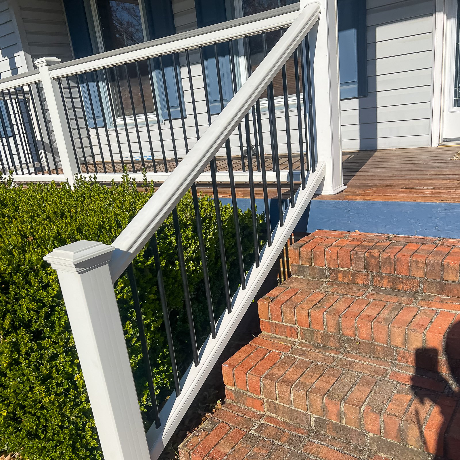 Front Porch Builder project featuring a completed front porch railing installation in Chesapeake