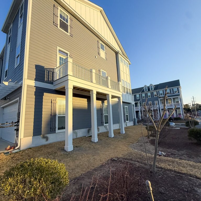 Elevated composite deck with white support posts and railings at a Norfolk home