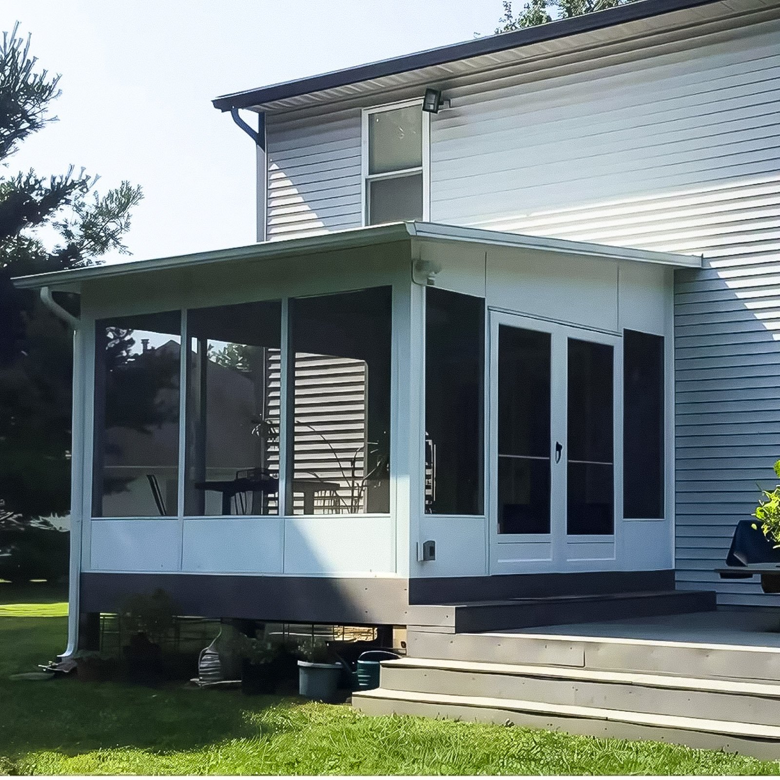 Covered Screen Room Builder project featuring a covered screen room with a white aluminum roof and exterior door