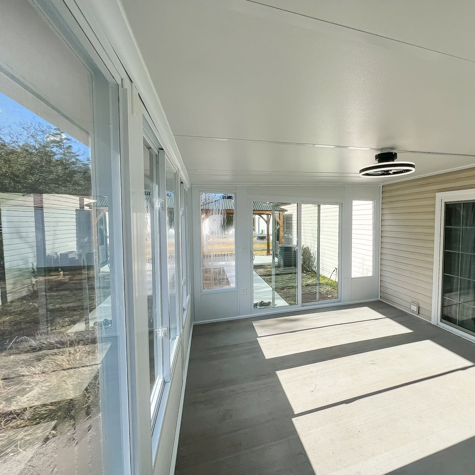 Three-season sunroom addition with large windows by an Outdoor Living Contractor in Virginia Beach