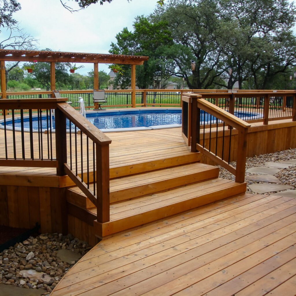 Wood deck built around a backyard pool by an Outdoor Living Contractor in Poquoson