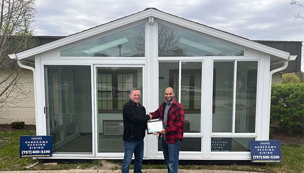 Joyce Manufacturing award presentation to Modern Exteriors by Design in front of a completed sunroom