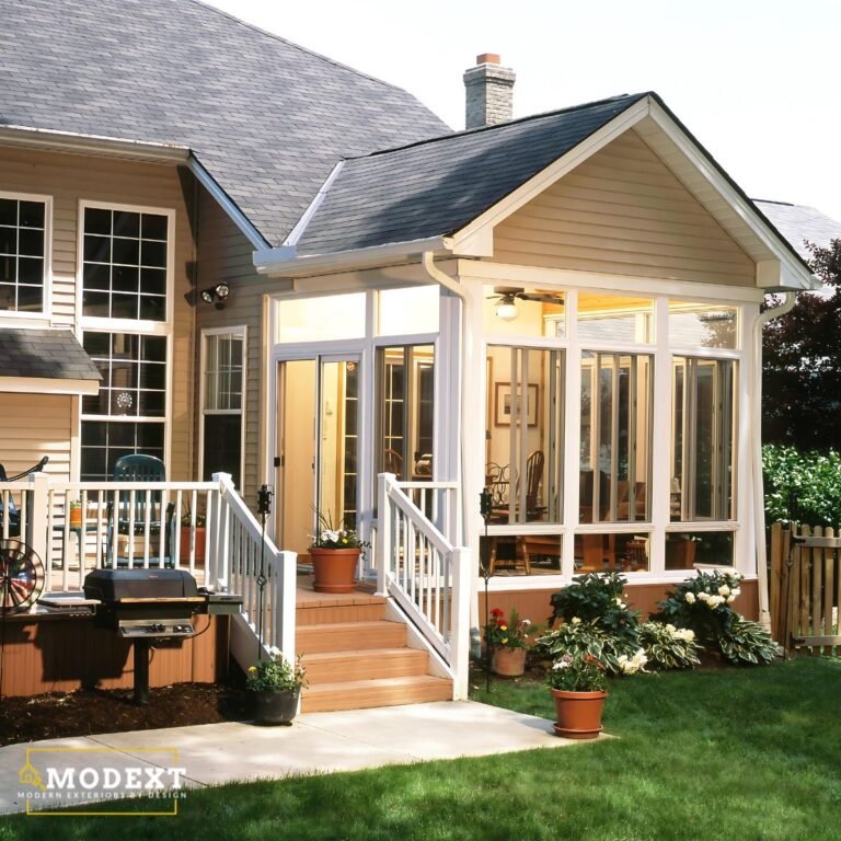 Enclosed porch with large windows connecting the home to the outdoors.